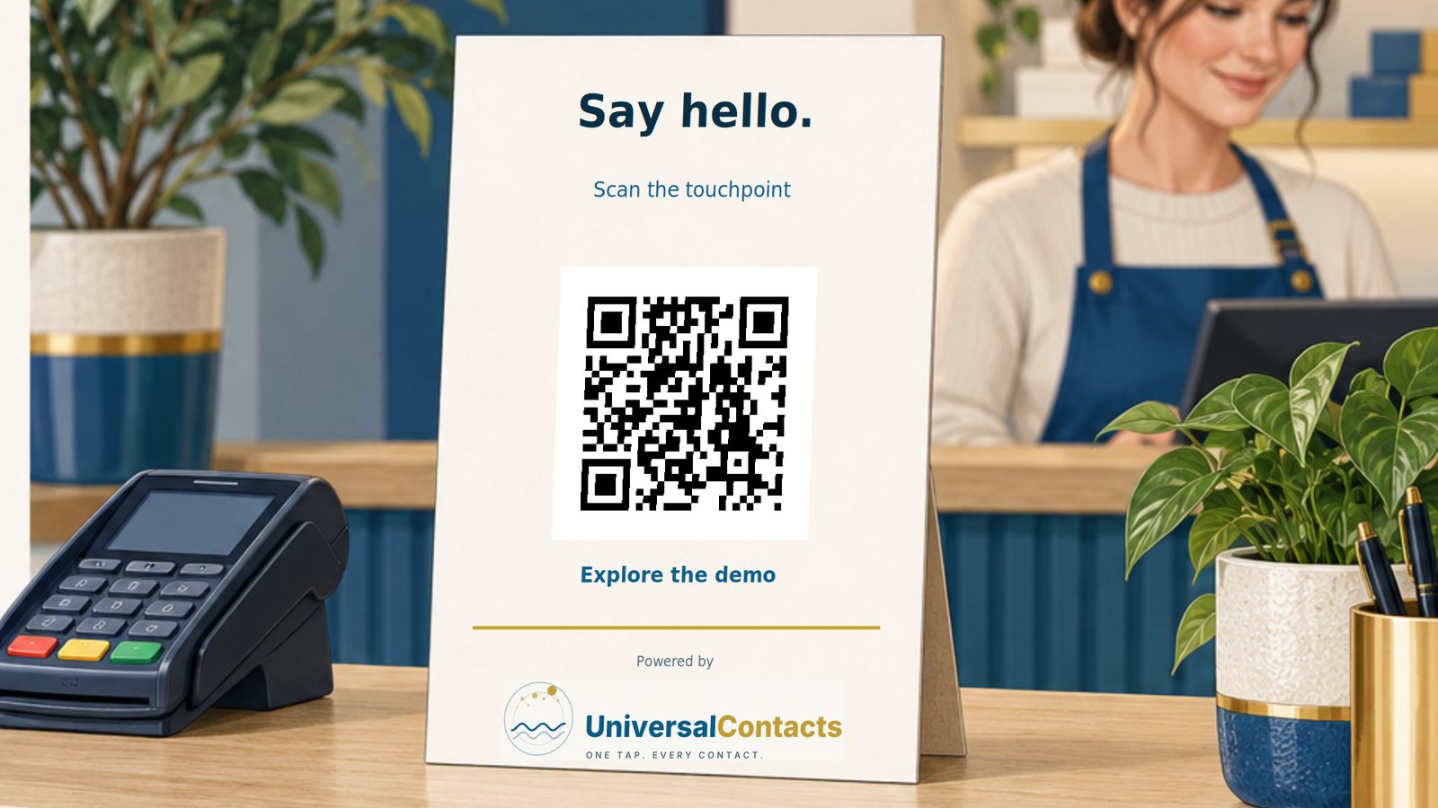 A counter stand beside a card terminal on a shop counter, its touchpoint facing the customer.